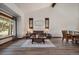 Cozy living room featuring wood floors, a leather sofa, stylish decor, and a large window at 8072 Windwood Way, Parker, CO 80134