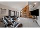 Cozy living room features brick fireplace, plush seating, and plenty of natural light at 8072 Windwood Way, Parker, CO 80134
