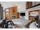 Inviting living room features a brick fireplace, stylish decor, and plenty of space for relaxation at 8072 Windwood Way, Parker, CO 80134