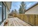 Wide angle view of wooden back deck and tall wood fence at 1696 Geneva Cir, Longmont, CO 80503