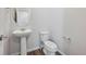 A sleek powder bathroom with a pedestal sink and modern fixtures at 2169 Flower Blossom Ave, Brighton, CO 80601