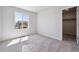 Bedroom featuring neutral walls, carpeted floors, and natural light from the window at 2169 Flower Blossom Ave, Brighton, CO 80601