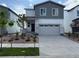Charming two-story home featuring a gray exterior, two-car garage, and a well-maintained front yard at 2169 Flower Blossom Ave, Brighton, CO 80601
