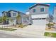 Charming gray and white two-story home with a two-car garage, landscaped front yard, and inviting covered porch at 2169 Flower Blossom Ave, Brighton, CO 80601