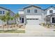 Attractive gray and white two-story home with a two-car garage, landscaped front yard, and covered entrance at 2169 Flower Blossom Ave, Brighton, CO 80601