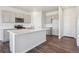 A bright kitchen featuring stainless steel appliances, gray cabinets, and a spacious countertop at 2169 Flower Blossom Ave, Brighton, CO 80601