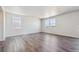 A large living room featuring natural light and hardwood floors at 2169 Flower Blossom Ave, Brighton, CO 80601