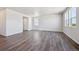 A spacious living room featuring lots of natural light and hardwood floors at 2169 Flower Blossom Ave, Brighton, CO 80601