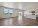 Open-concept living area with hardwood floors, natural light, and access to the backyard at 2169 Flower Blossom Ave, Brighton, CO 80601