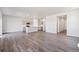 Spacious open-concept living area showcasing the modern kitchen and hardwood floors at 2169 Flower Blossom Ave, Brighton, CO 80601