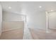 Bright loft area featuring neutral walls, carpeted floors, and natural light from the window at 2169 Flower Blossom Ave, Brighton, CO 80601