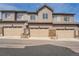 Townhome featuring a three-car garage, neutral siding, and well-maintained landscaping at 6777 S Old Hammer Ct, Aurora, CO 80016
