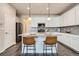 Modern kitchen featuring white cabinets, granite countertops, and a stylish breakfast bar area at 6777 S Old Hammer Ct, Aurora, CO 80016