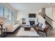 Inviting living room with a fireplace, stylish furniture, and a staircase leading to the upper level at 6777 S Old Hammer Ct, Aurora, CO 80016