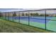 Well-maintained tennis court with vibrant colors and surrounding greenery, perfect for recreational play at 6777 S Old Hammer Ct, Aurora, CO 80016