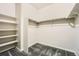 Walk-in closet with custom shelving, carpeted floor, and ample storage space for clothing and accessories at 6777 S Old Hammer Ct, Aurora, CO 80016
