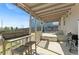 Covered patio with outdoor grill, bench seating, and a view of the backyard at 3732 S Halifax St, Aurora, CO 80013