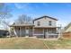 Large backyard with grass, patio with porch, and a gray two-story home at 3732 S Halifax St, Aurora, CO 80013