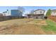 Large backyard with well maintained lawn and a view of the grey two-story home at 3732 S Halifax St, Aurora, CO 80013