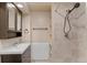 Cozy bathroom with vanity, sink, shower with tile surround, and towel bar at 3732 S Halifax St, Aurora, CO 80013