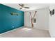 A blue accent wall adds a pop of color to this carpeted bedroom with ceiling fan and window at 3732 S Halifax St, Aurora, CO 80013