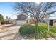 Traditional two-story home with mature tree, green lawn, and two car garage on a sunny day at 3732 S Halifax St, Aurora, CO 80013