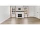 Cozy living room features wood floors, an electric fireplace, and natural light from the windows at 3732 S Halifax St, Aurora, CO 80013