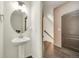 Small bathroom featuring a white pedestal sink and modern fixtures next to a stairway at 5251 Truckee St, Denver, CO 80249