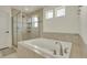 Bathroom featuring a large soaking tub and a separate glass-enclosed shower at 5251 Truckee St, Denver, CO 80249