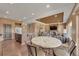 Open-concept dining room with a fireplace, an elegant table and chairs adjacent to the kitchen at 5251 Truckee St, Denver, CO 80249