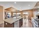 Kitchen with a large island, barstool seating, granite countertops, and stainless steel appliances overlooking the living room at 5251 Truckee St, Denver, CO 80249
