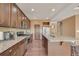 Well-lit kitchen featuring granite counters, stainless steel appliances, and beautiful wood flooring at 5251 Truckee St, Denver, CO 80249
