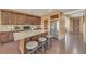 Kitchen with a large island, barstool seating, granite countertops, and stainless steel appliances at 5251 Truckee St, Denver, CO 80249