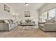Bright living room with a neutral color scheme, gray couches, and a large window for natural light at 5251 Truckee St, Denver, CO 80249