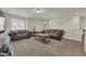 Relaxing living room featuring brown leather couches and a wooden coffee table on carpeted floors at 5251 Truckee St, Denver, CO 80249