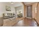 Living room with hardwood floors, neutral colored walls, and a glass coffee table with a gray couch at 5251 Truckee St, Denver, CO 80249