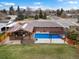 Aerial view of a brick home with a backyard pool, patio, and covered outdoor living space at 2698 E Cresthill Ave, Centennial, CO 80121