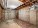 Unfinished basement with concrete walls, ceiling beams, and a small window at 2698 E Cresthill Ave, Centennial, CO 80121