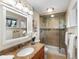 Well-lit bathroom with a granite countertop, glass shower, and neutral decor for a clean, fresh feel at 2698 E Cresthill Ave, Centennial, CO 80121