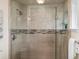 A tiled shower with a frameless glass door adds a spa-like retreat to this bathroom at 2698 E Cresthill Ave, Centennial, CO 80121