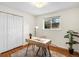 Bright bedroom features natural light, hardwood floors, and closet at 2698 E Cresthill Ave, Centennial, CO 80121