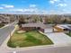 Aerial view of a brick home with a well-manicured lawn and attached two-car garage at 2698 E Cresthill Ave, Centennial, CO 80121