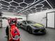 Modern garage boasts custom lighting, epoxy flooring, a sports car and a motorcycle at 2698 E Cresthill Ave, Centennial, CO 80121