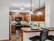 Traditional kitchen with wood cabinets, stainless steel appliances, and breakfast bar with leather stools at 2698 E Cresthill Ave, Centennial, CO 80121