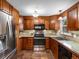 Well-equipped kitchen with stainless steel appliances, tile backsplash, and hardwood cabinets at 2698 E Cresthill Ave, Centennial, CO 80121