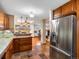 The kitchen features stainless steel appliances, hardwood cabinets, and stone counter tops at 2698 E Cresthill Ave, Centennial, CO 80121