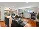 Cozy living room featuring hardwood floors, a fireplace, and views of the connected dining area at 2698 E Cresthill Ave, Centennial, CO 80121