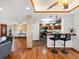 Spacious living room area showcasing hardwood flooring, and open bar concept to kitchen at 2698 E Cresthill Ave, Centennial, CO 80121