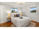 Bright bedroom with hardwood floors, neutral decor, and large windows offering pleasant natural light at 2698 E Cresthill Ave, Centennial, CO 80121