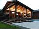 Outdoor living space with stone fireplace, TV, lighting, and tiered stairs leading to a pool at 2698 E Cresthill Ave, Centennial, CO 80121